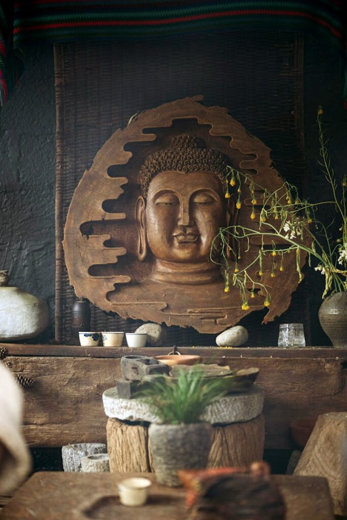 Mastering the First Impression: Your intriguing post title goes here Wooden Buddha relief with rustic decor and plants, creating a serene ambiance.